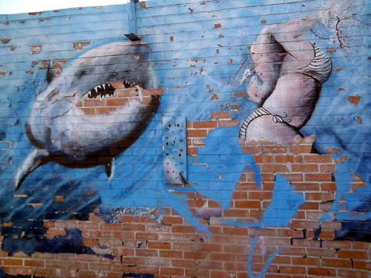 "Bait" by Amber Campagna. The paint is falling off the wall - which makes it especially interesting in an odd way.