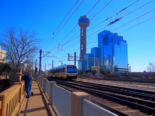 This is the walkway along the rail tracks over the underpass, with the Dallas Hyatt Regency and Reunion Tower in the background.