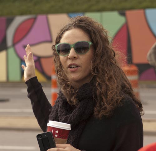 Docent giving a talk on the murals in front of the Belmont Hotel