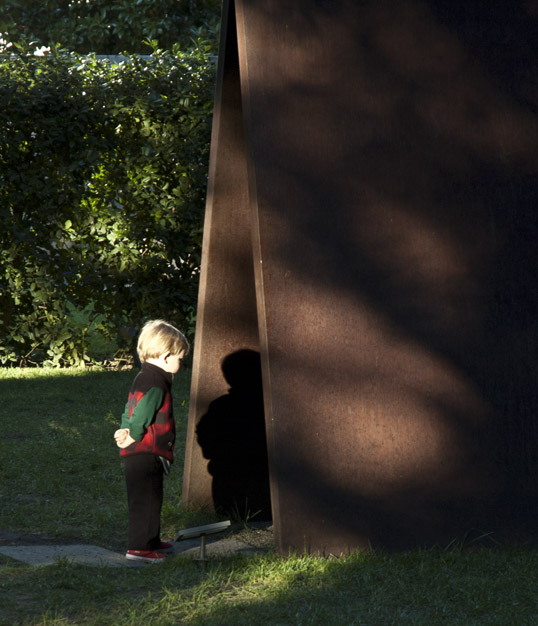 Boy looking at his shadow on Richard Serra's My Curves Are Not Mad - Nasher Sculpture Center, Dallas, Texas