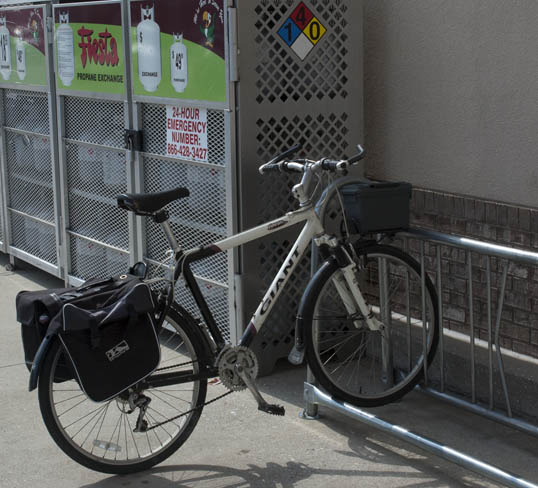 My commuter bike, with panniers, waiting at the Fiesta Mark bike rack.