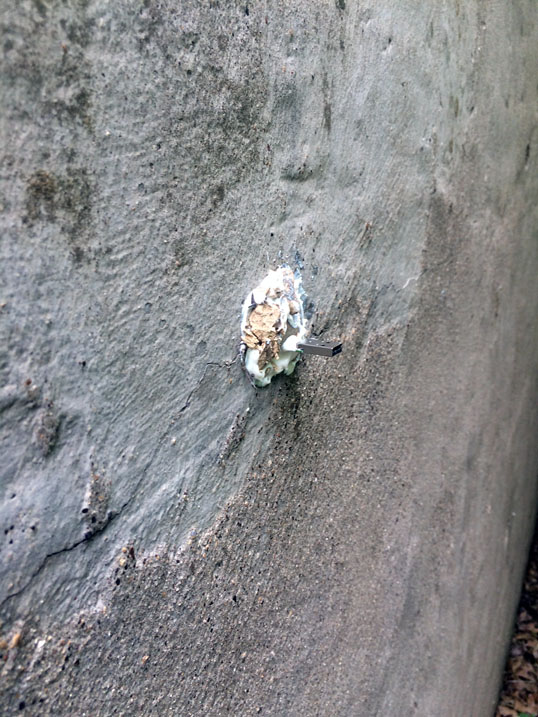 Close up view of the USB Dead Drop mounted in the concrete.