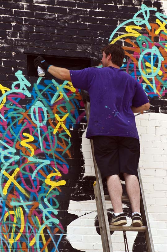 Eric Mancini painting a mural of Jean-Michel Basquiat Downtown Dallas, Texas