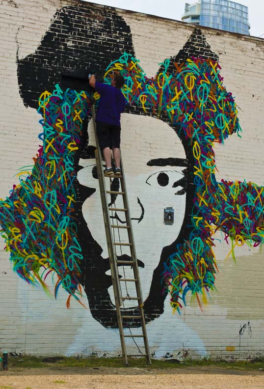 Eric Mancini painting a mural of Jean-Michel Basquiat Downtown Dallas, Texas